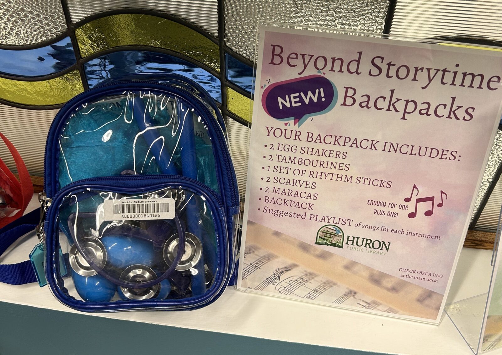 a photo of the beyond storytime backpack and a sign with everything the backpack includes
